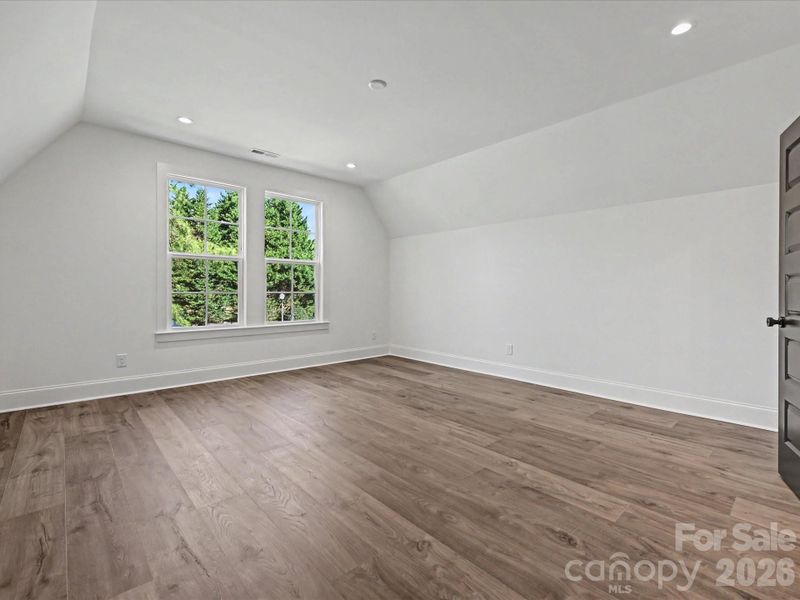 Large secondary bedroom featuring abundant natural light, neutral finishes, and versatile space for guests or a home office.
