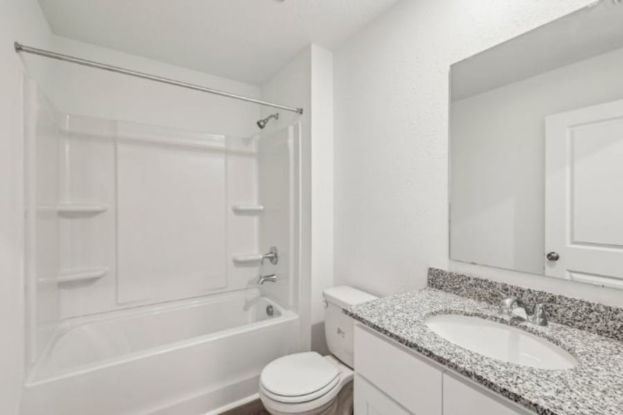 A bathroom with a sink toilet and bathtub.