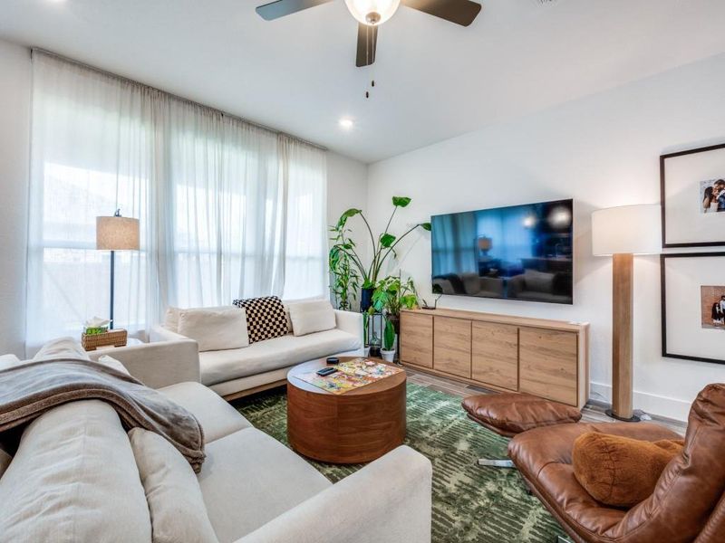 Living room with ceiling fan, recessed lighting, and wood finished floors