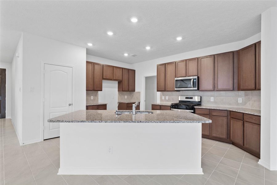 Thoughtfully designed as the true heart of the home, this kitchen serves as a warm and inviting centerpiece for both daily living and effortless entertaining.