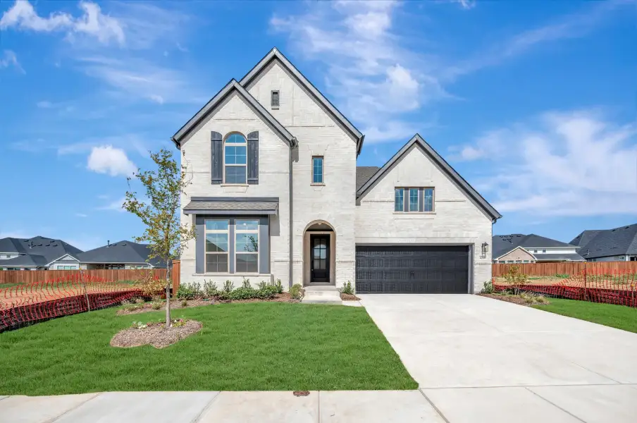Front exterior of a new home in Sandbrock Ranch, Aubrey, TX, highlighting curb appeal (Image 1). Front exterior of a new home in Sandbrock Ranch, Aubrey, TX, highlighting curb appeal (Image 1).