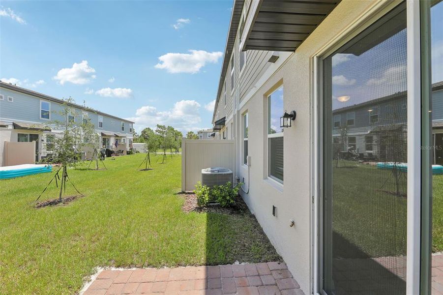 Exterior details and patio area of a home in The Meadow at Crossprairie Townes, St. Cloud (Image 26).