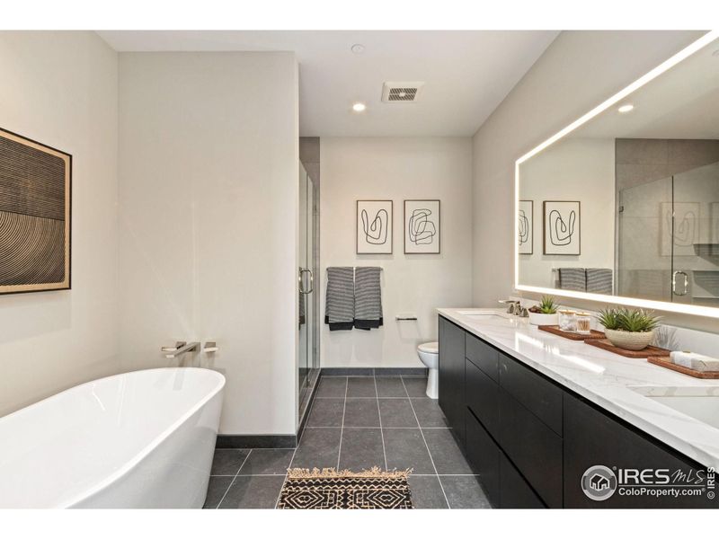 Huge 5 peice primary ensuite with lots of counter space, a large shower, 59 in., free-standing tub and a lit mirror.