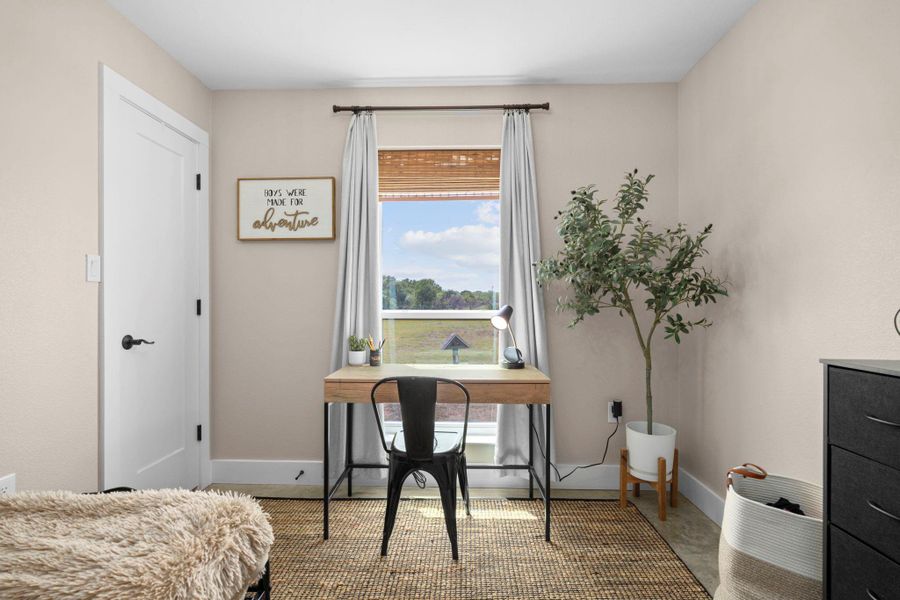 Bedroom featuring baseboards and an office area