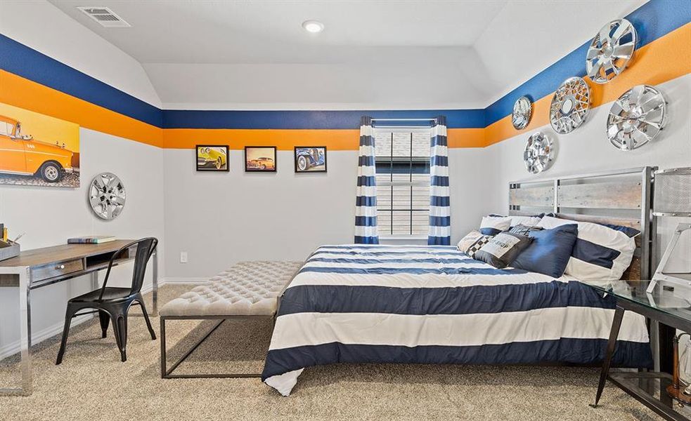 Carpeted bedroom featuring vaulted ceiling