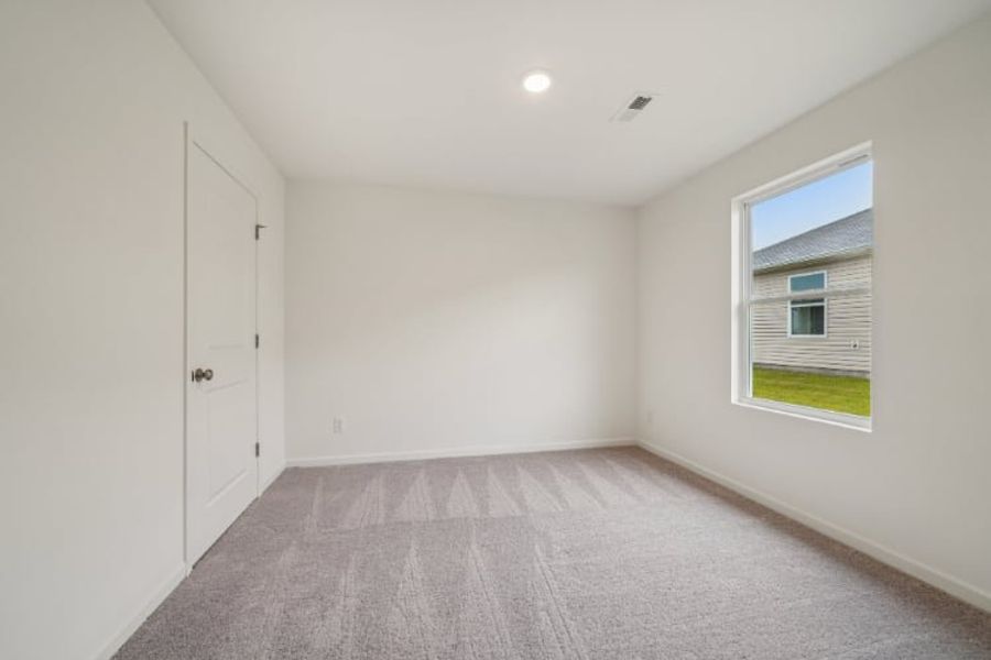 A room with white walls and a window.