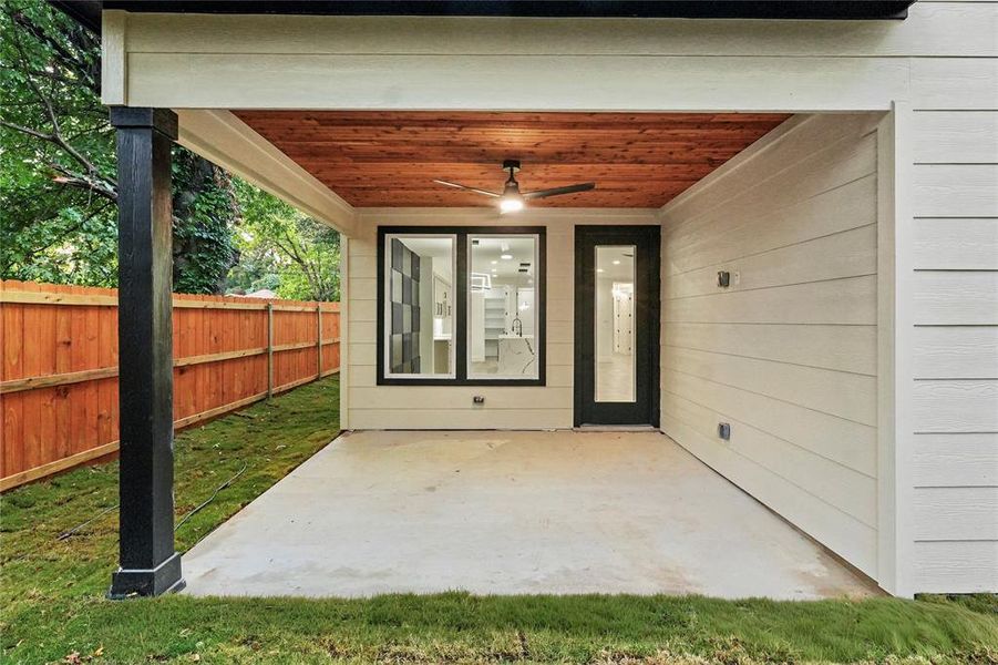 Property entrance featuring ceiling fan and a patio Property entrance featuring ceiling fan and a patio