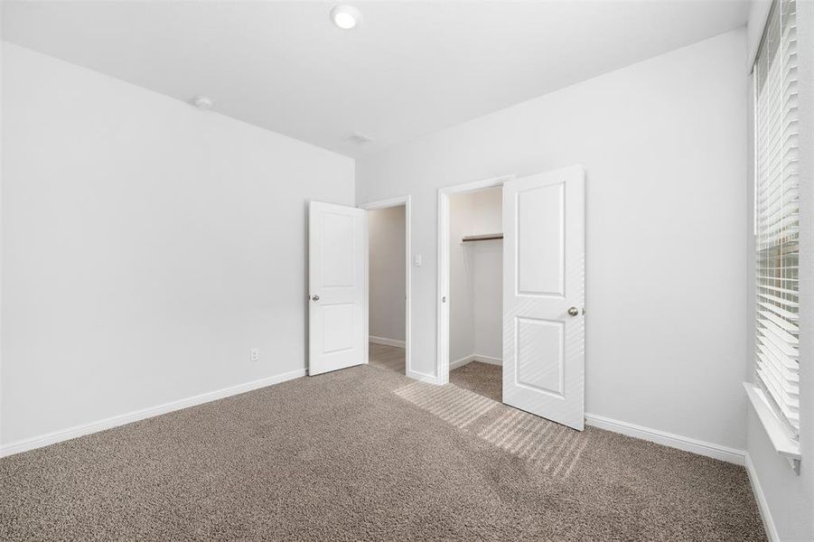 Unfurnished bedroom featuring carpet floors and a closet