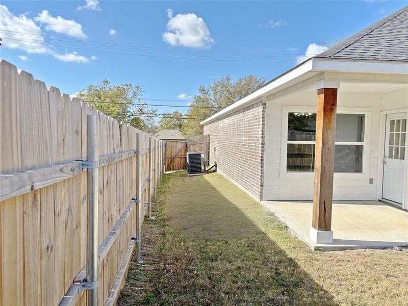 Fenced backyard featuring a patio