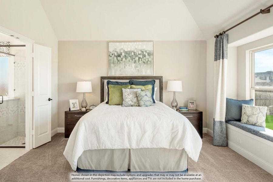 Master bedroom with vaulted ceiling, window seat, carpet flooring, and ensuite bathroom door visible