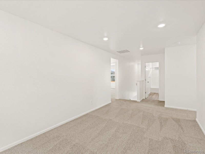 Spacious, unfurnished interior of a new home in Ridgeline Vista: The Flora Collection, Brighton (Image 19).