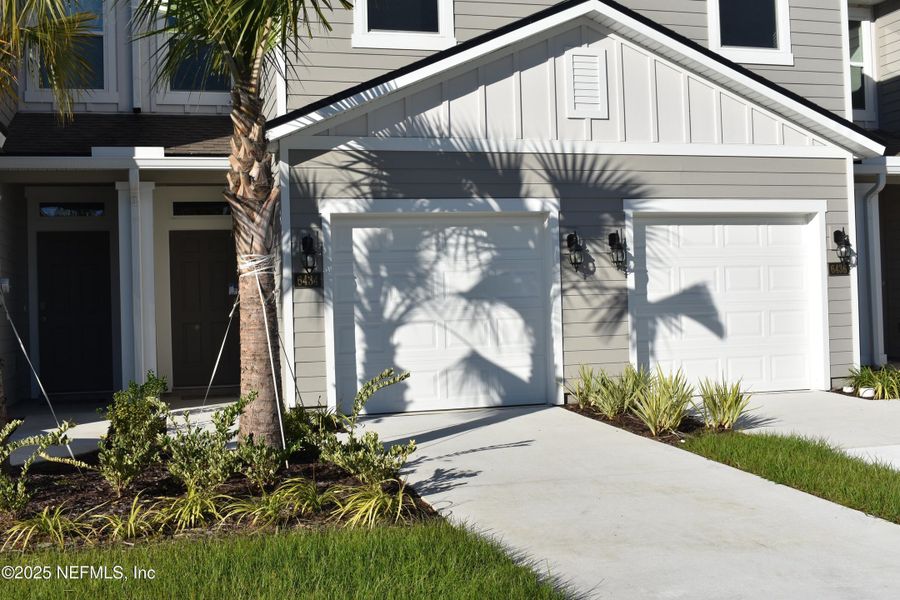 Front exterior of a new home in Old Kings Trail, Jacksonville, FL, highlighting curb appeal (Image 1).