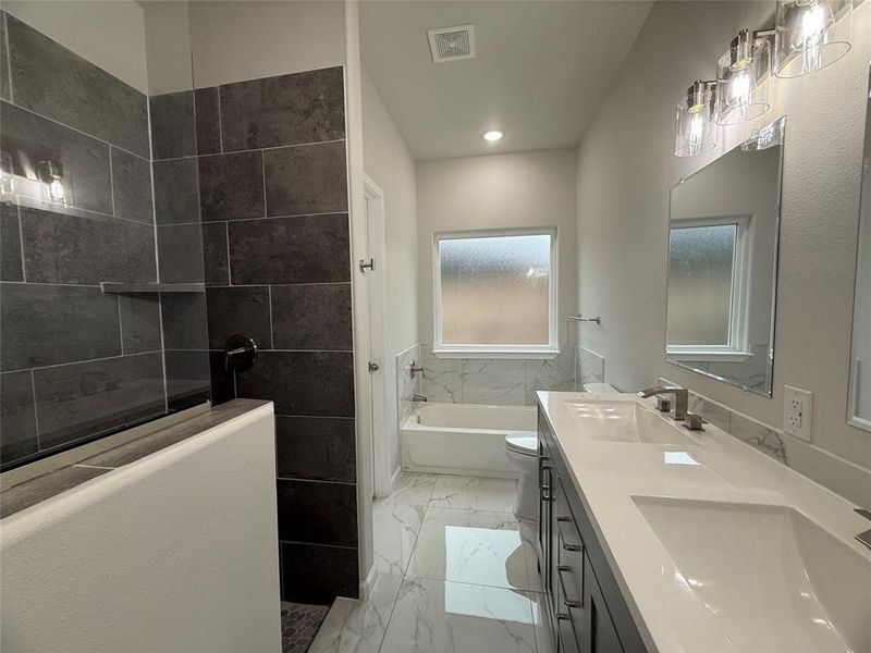 Full bathroom featuring vanity, toilet, and plus walk in shower