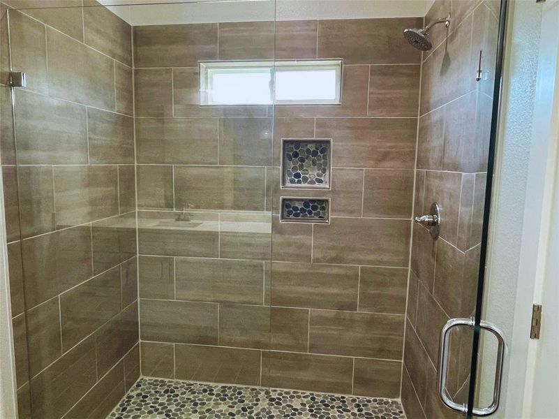 Bathroom featuring a shower with shower door