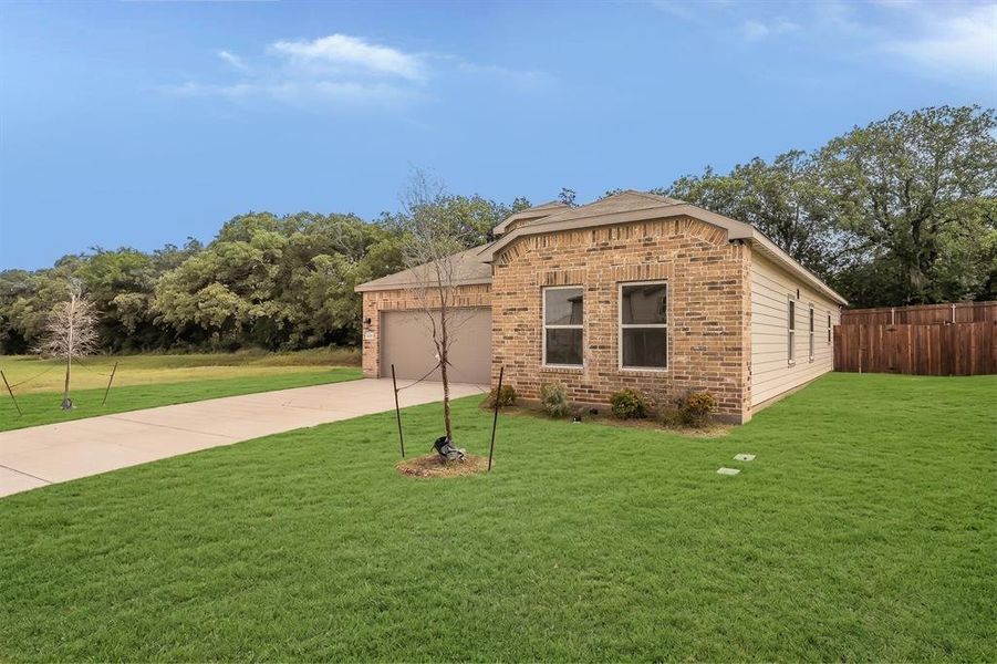 Front exterior of a new home in Courtland Place, Cleburne, TX, highlighting curb appeal (Image 17). Front exterior of a new home in Courtland Place, Cleburne, TX, highlighting curb appeal (Image 17).