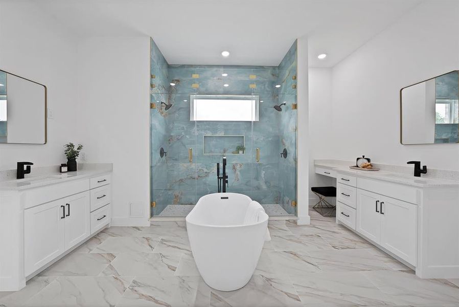White freestanding tub, dual vanity areas with white cabinetry and light countertops, a spacious glass-enclosed shower with blue-patterned tile, recessed lighting, and large format floor tiling