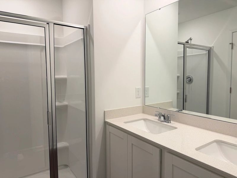 Primary Bath - Clean geometry and high-contrast finishes.