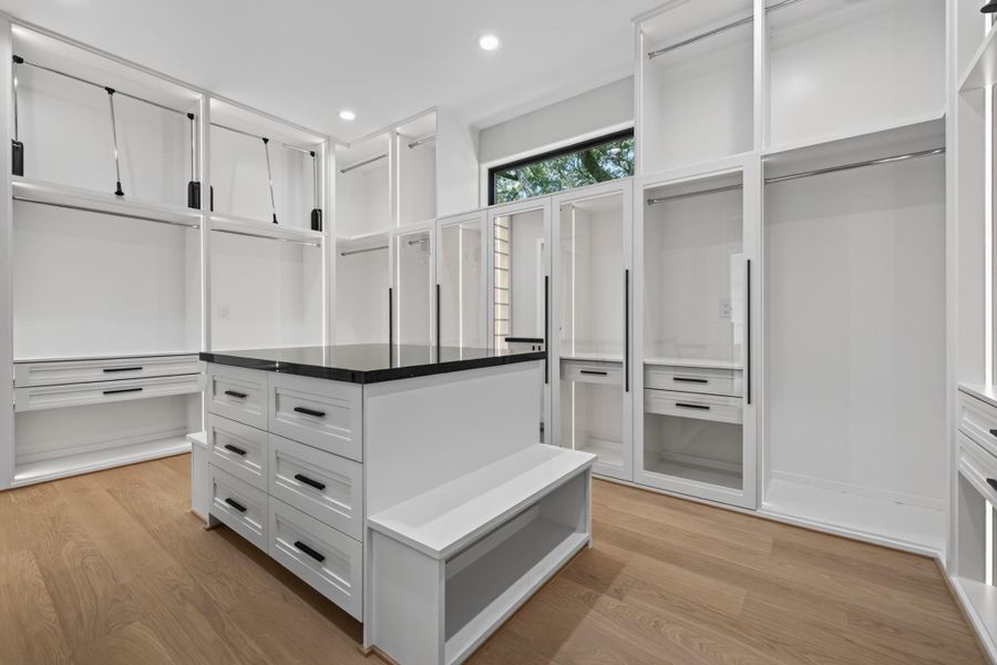 Custom walk-in closet with built-in shelving and abundant storage space.