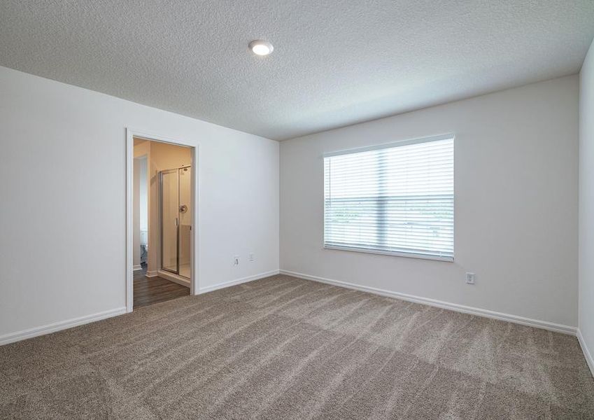 The carpeted master bedroom has one large window and its own full bathroom.