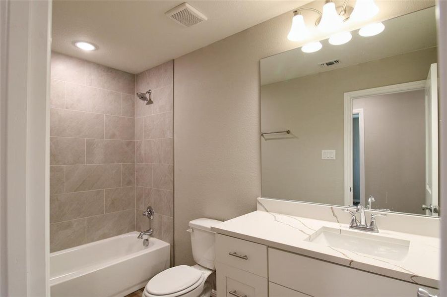 Full bathroom featuring shower / bath combination and vanity