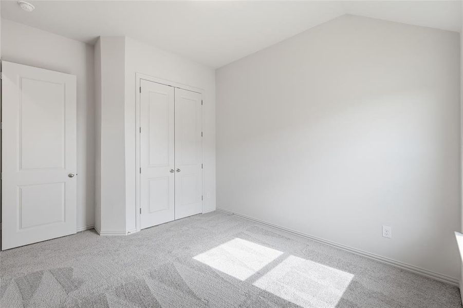 Room featuring light gray carpeting, neutral wall finishes, and white trim Room featuring light gray carpeting, neutral wall finishes, and white trim