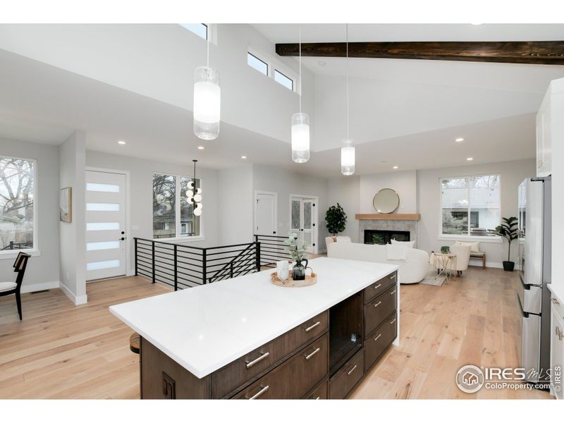 Single slab island with modern pendant lights.