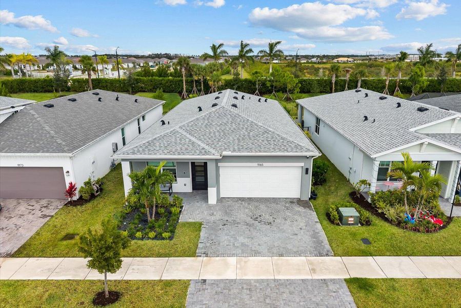 Front exterior of a new home in Tradition - Kenley, Port St. Lucie, FL, highlighting curb appeal (Image 1). Front exterior of a new home in Tradition - Kenley, Port St. Lucie, FL, highlighting curb appeal (Image 1).