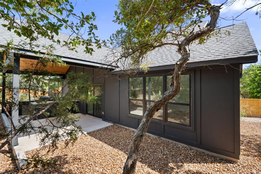 View of home's exterior with a shingled roof, a sunroom, and board and batten siding View of home's exterior with a shingled roof, a sunroom, and board and batten siding