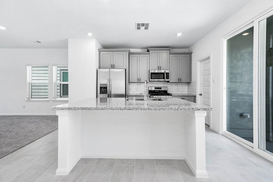 Additional view of the kitchen featuring the generous counter space, and ample cabinetry. Additional view of the kitchen featuring the generous counter space, and ample cabinetry.