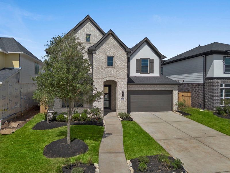 Front exterior of a new home in Sienna 45', 50', Missouri City, TX, highlighting curb appeal (Image 1).