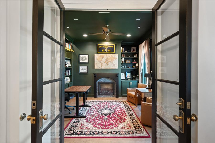 The downstairs home office features glass doors that can be closed for added privacy while still allowing natural light to flow through.