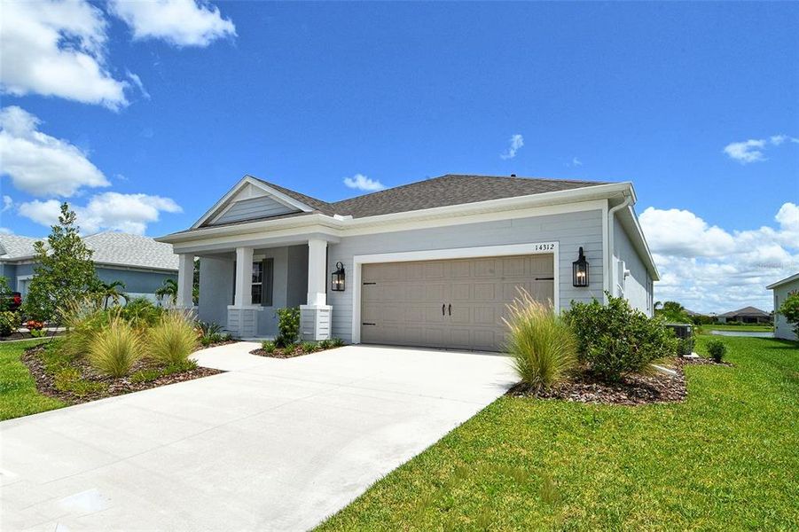 Front exterior of a new home in Canoe Creek, Parrish, FL, highlighting curb appeal (Image 2).