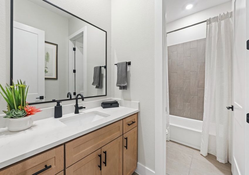 The secondary bathroom has an extended vanity space.