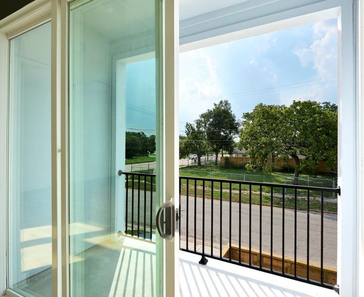 Step out onto the second-story balcony and enjoy the breeze and panoramic views. This elevated outdoor space is perfect for relaxing with a morning coffee or watching the sunset over the neighborhood. Step out onto the second-story balcony and enjoy the breeze and panoramic views. This elevated outdoor space is perfect for relaxing with a morning coffee or watching the sunset over the neighborhood.