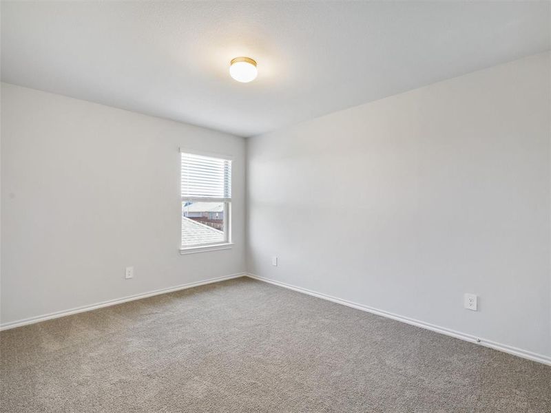 Empty room with baseboards and carpet flooring Empty room with baseboards and carpet flooring