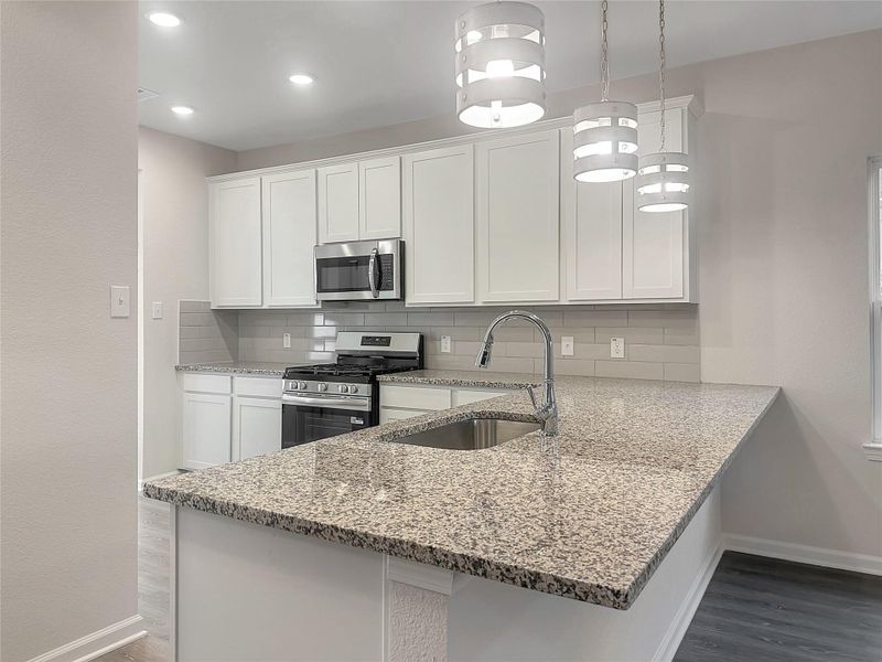 The Caldwell-  Kitchen. Home is under construction. Sample image for illustration; upgrades, options, and colors may vary.