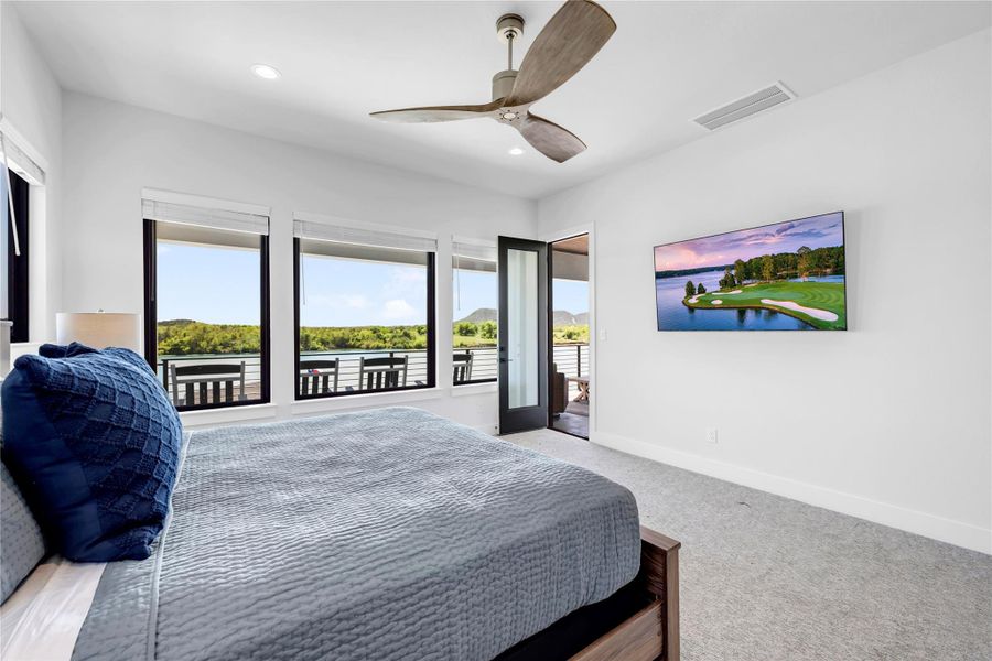 Bedroom three: Generous windows frame scenic outdoor vistas in this inviting carpeted bedroom suite.