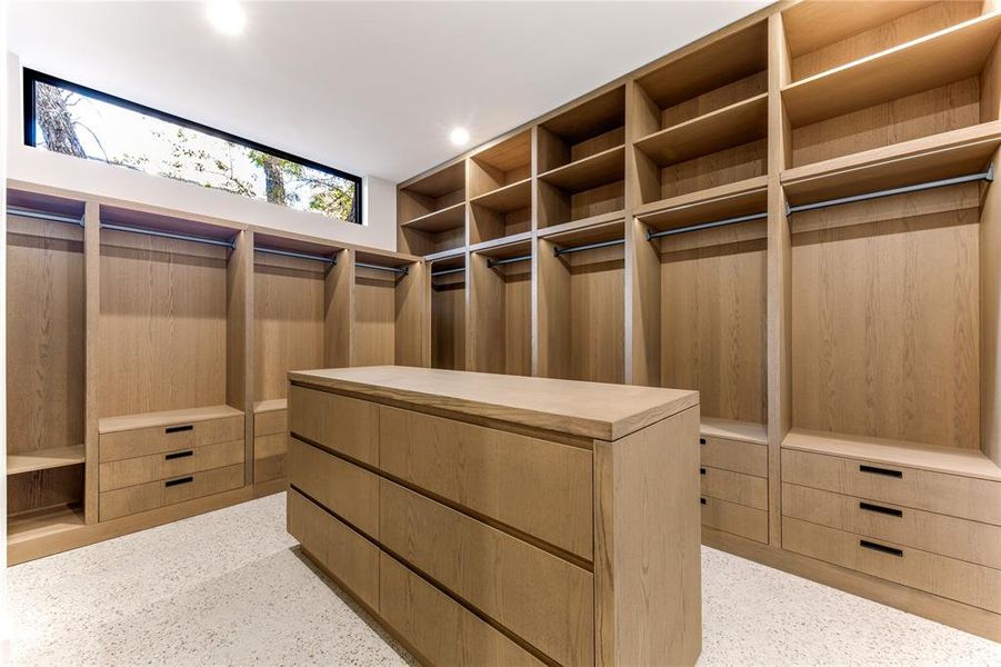 View of spacious primary custom closet with integrated lighting