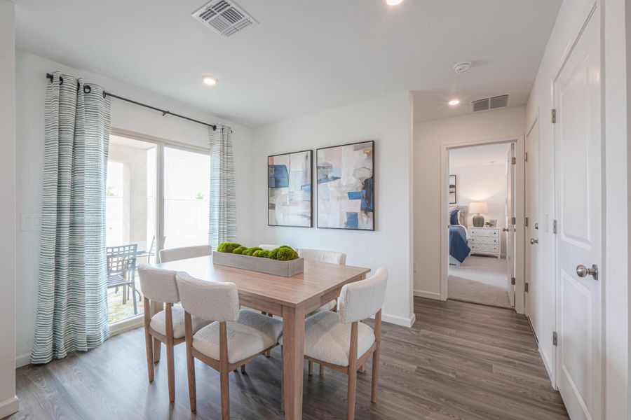 A dining room with a table and chairs.