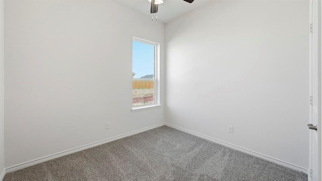 Spare room featuring carpet flooring and a ceiling fan Spare room featuring carpet flooring and a ceiling fan
