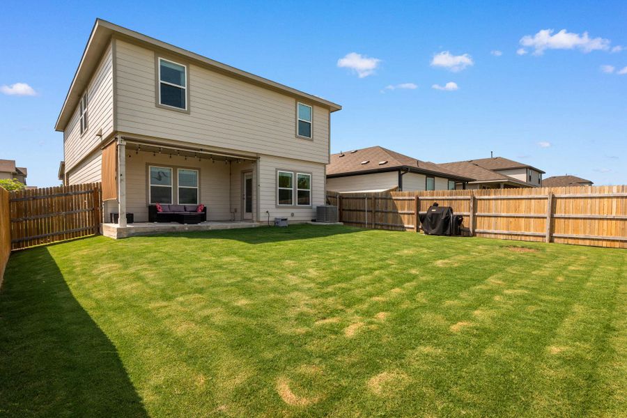 A spacious backyard with a private fence offers an ideal setting for relaxation and outdoor entertaining. A spacious backyard with a private fence offers an ideal setting for relaxation and outdoor entertaining.