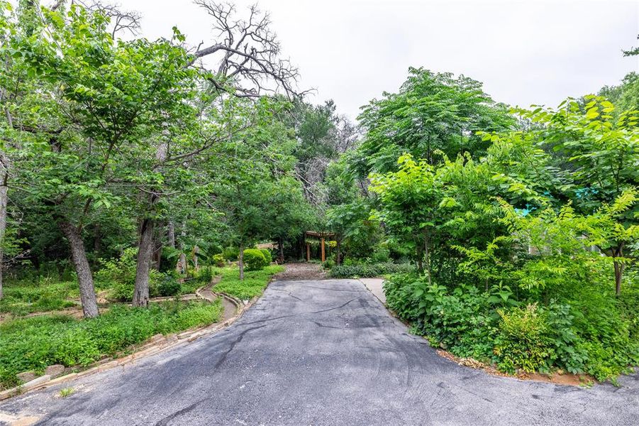 Road from entrance of your property all the way to the shop which has room for several cars and all of your toy storage needs