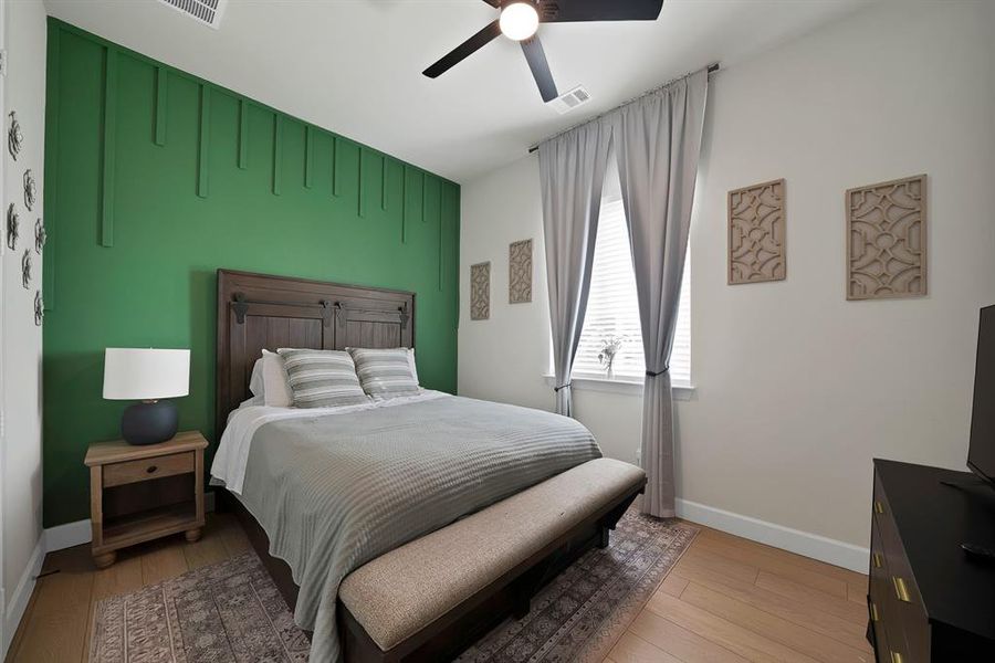 Room featuring a vibrant green accent wall with decorative vertical paneling Room featuring a vibrant green accent wall with decorative vertical paneling
