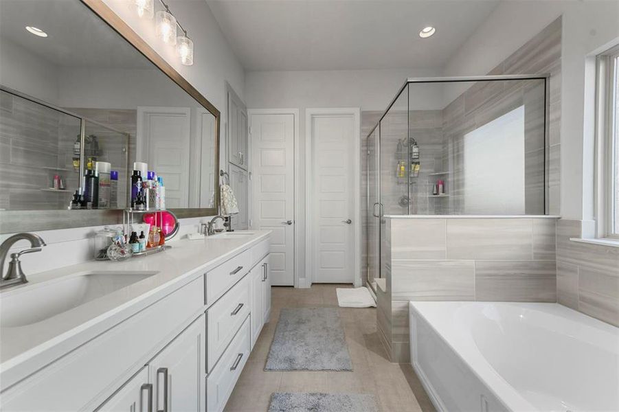 Bathroom with vanity, independent shower and bath, and tile patterned flooring