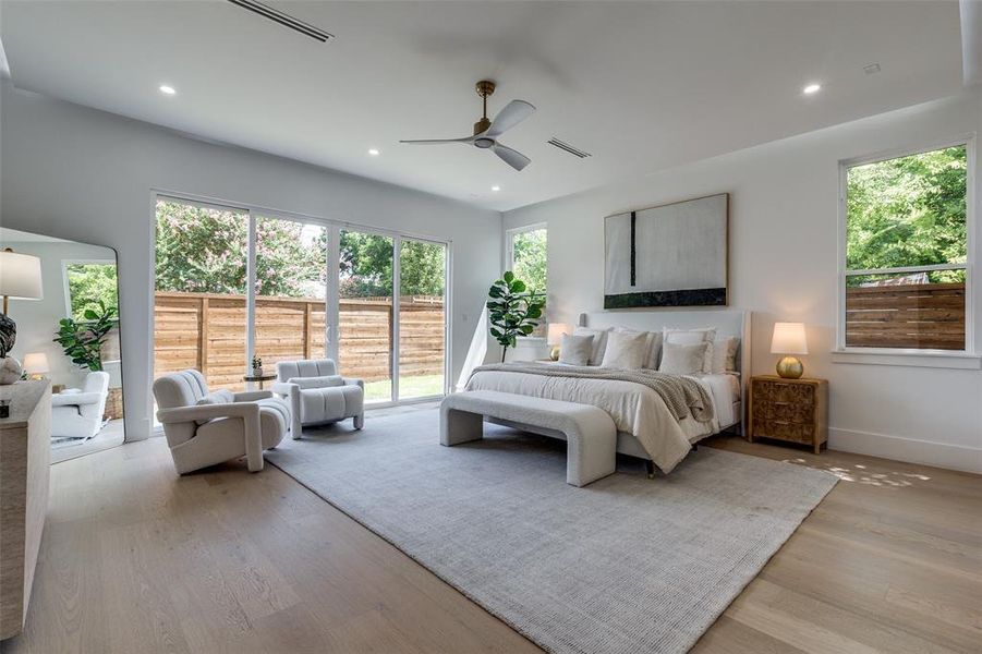 Bedroom featuring ceiling fan, light hardwood / wood-style flooring, and access to outside