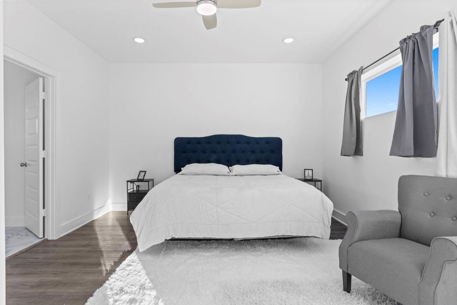 Elegant primary bedroom with large windows and abundant natural light.