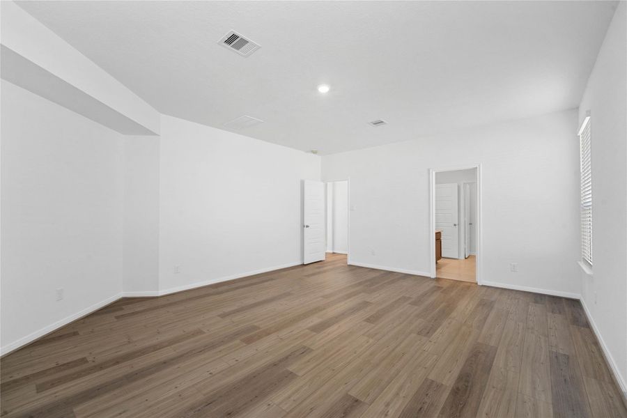 Additional view of the primary bedroom looking towards the primary bathroom.