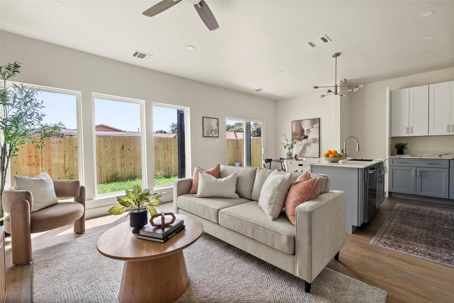 An inviting living space features high ceilings, recessed lighting, and ample natural light.