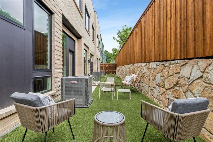 View of yard featuring an outdoor living space and central AC