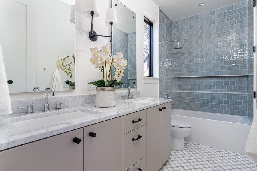 The second floor hosts two secondary bedrooms which share a jack 'n jill bathroom with a double vanity and tub.